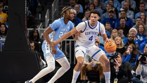 Dec 16, 2023; Atlanta, Georgia, USA; North Carolina Tar Heels forward Jae'Lyn Withers (24) defends the goal against Kentucky Wildcats forward Tre Mitchell (4) during the second half at State Farm Arena. Mandatory Credit: Jordan Godfree-USA TODAY Sports